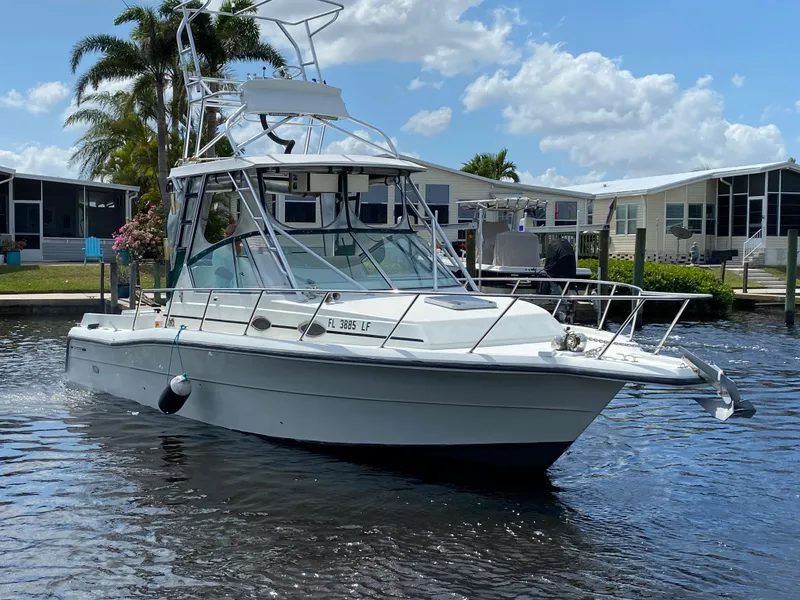 Slide: The Image of 1997 Stamas 310 Express boat on a sunny day in a residential canal. - 45