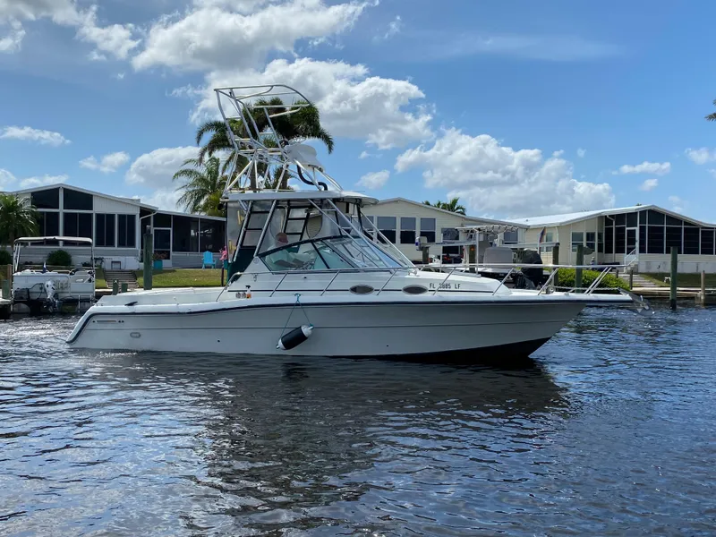 Slide: The Image of 1997 Stamas 310 Express boat on water near residential docks. - 47