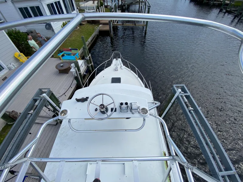 Slide: The Image of View from the upper deck of a 1997 Stamas 310 Express boat docked by a waterfront. - 7