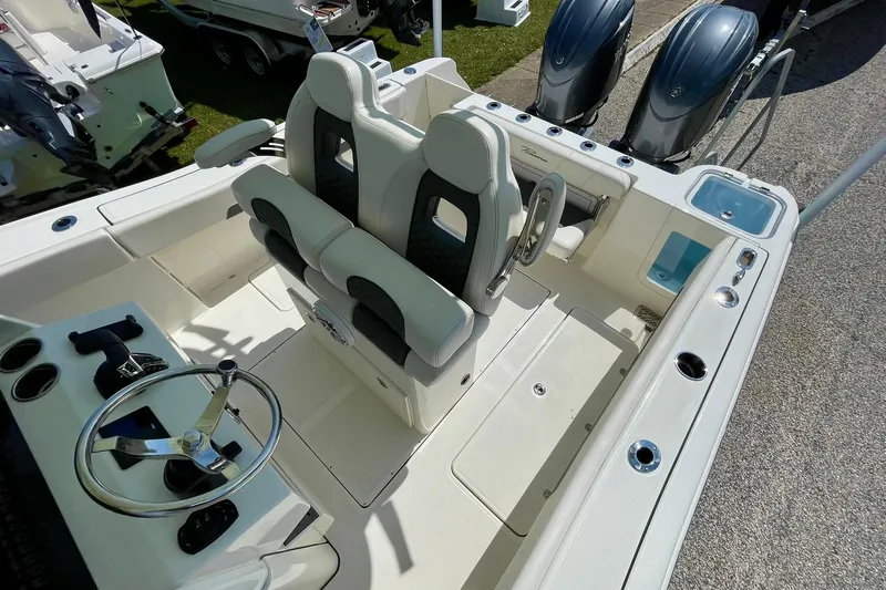 Slide: The Image of 2026 Pioneer 250 Pelagic boat interior with dual seats and steering console. - 10