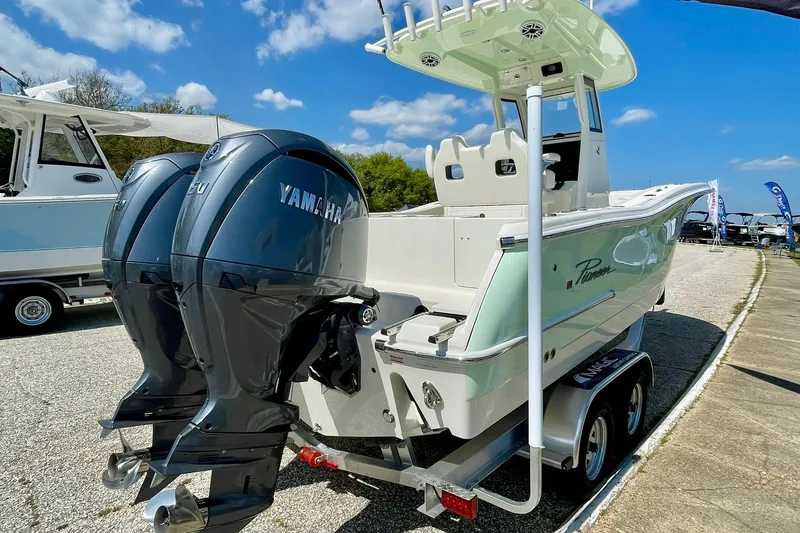 Slide: The Image of 2026 Pioneer 250 Pelagic boat with dual Yamaha engines on a trailer. - 11