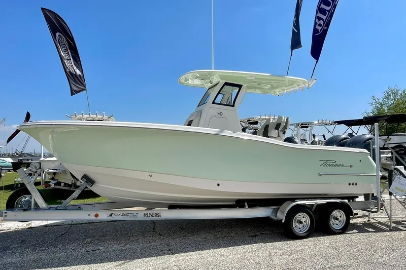 The Image of 2026 Pioneer 250 Pelagic boat on trailer, displayed outdoors with flags. - 3