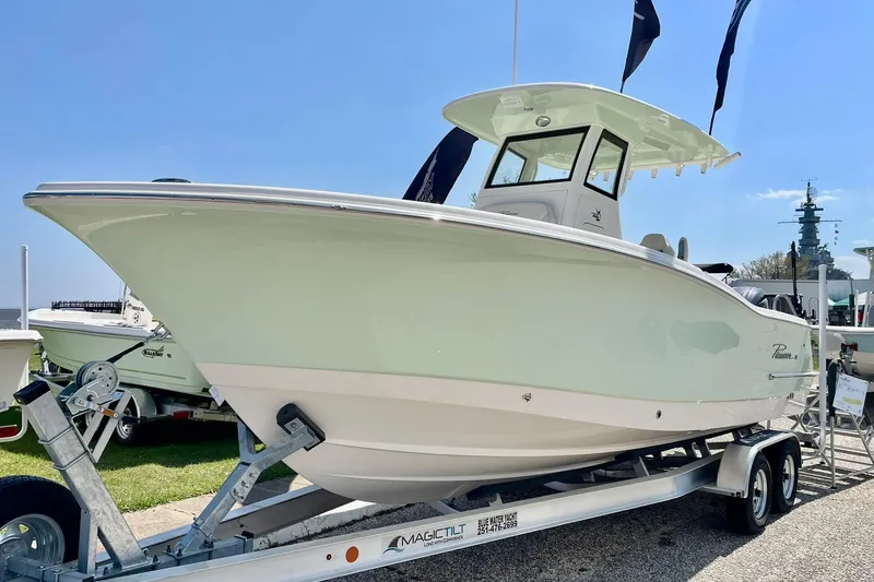 Slide: The Image of 2026 Pioneer 250 Pelagic boat on trailer, displayed outdoors under clear sky. - 4