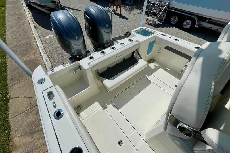 Slide: The Image of 2026 Pioneer 250 Pelagic boat interior with dual engines and seating area. - 8