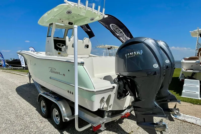 Slide: The Image of 2026 Pioneer 250 Pelagic boat with dual Yamaha engines on a trailer. - 9