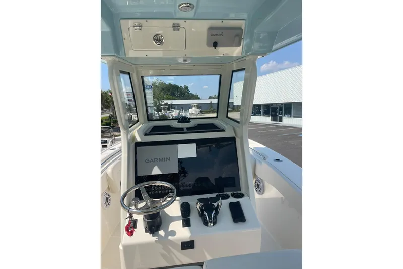 Slide: The Image of Helm of 2026 Pioneer 250 Pelagic boat with Garmin navigation system and steering wheel. - 10