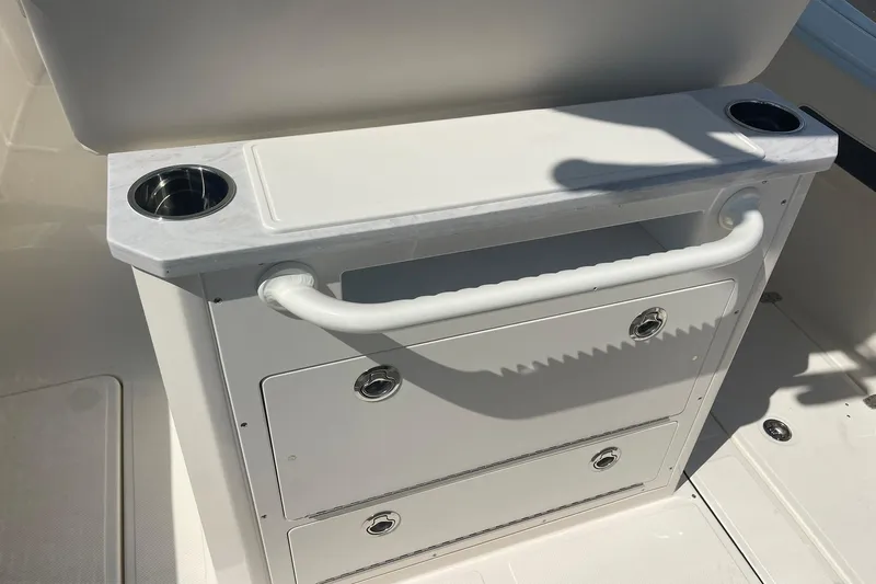 Slide: The Image of Interior of 2026 Pioneer 250 Pelagic boat with storage drawers and cup holders. - 11