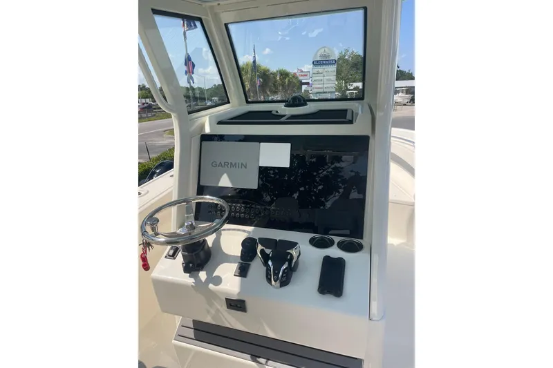 Slide: The Image of Helm of 2026 Pioneer 250 Pelagic boat with Garmin navigation system and steering wheel. - 3