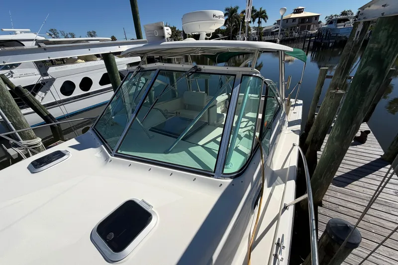 Slide: The Image of 2001 Pursuit 3000 Express boat docked at marina, clear sunny day. - 10