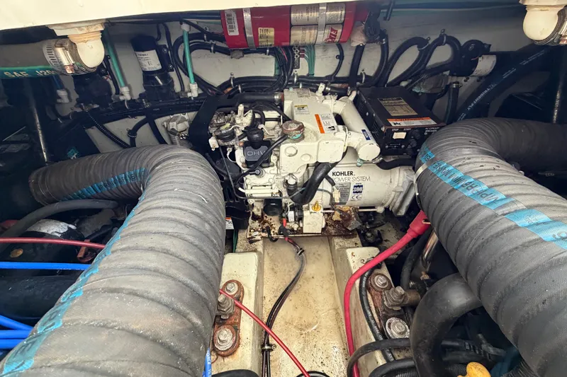 Slide: The Image of Engine compartment of a 2001 Pursuit 3000 Express boat, featuring Kohler power system. - 29