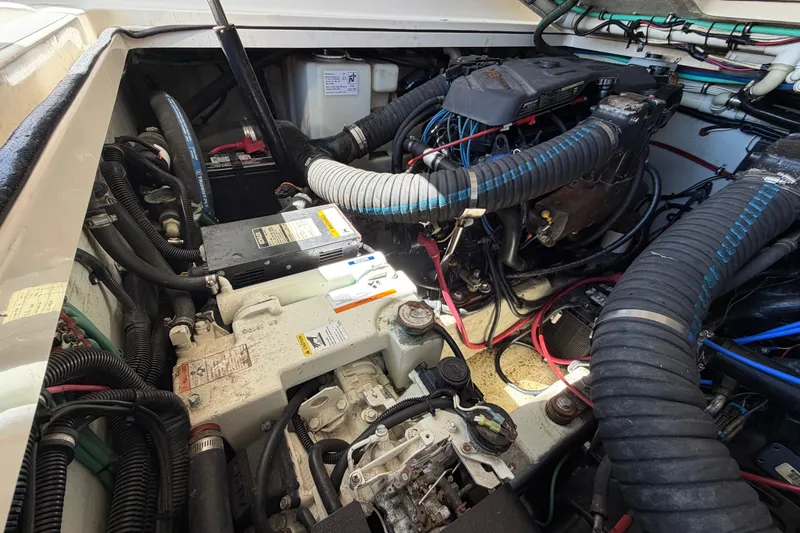 Slide: The Image of Engine compartment of a 2001 Pursuit 3000 Express boat, showcasing wiring and components. - 32