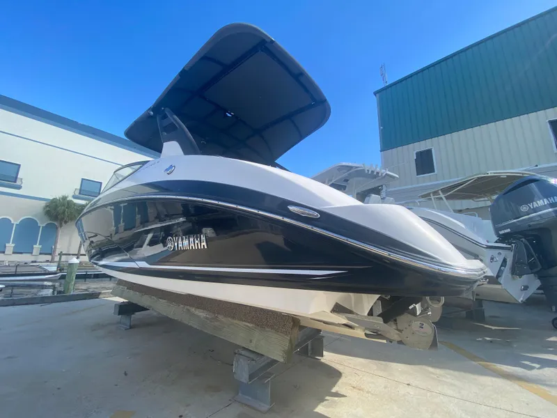 The Image of 2018 Yamaha Boats 242 Limited S on display in a marina setting. - 0