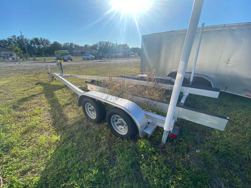 Slide: The Image of Boat trailer for 2018 Yamaha Boats 242 Limited S in sunny outdoor setting. - 20