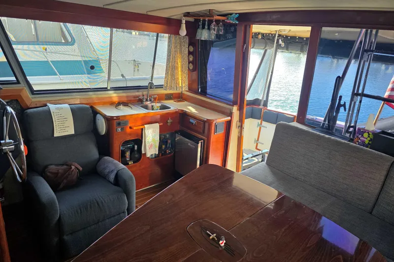 Slide: The Image of Interior of 1986 Bayliner 3870 Motoryacht with cozy seating and kitchenette. - 11