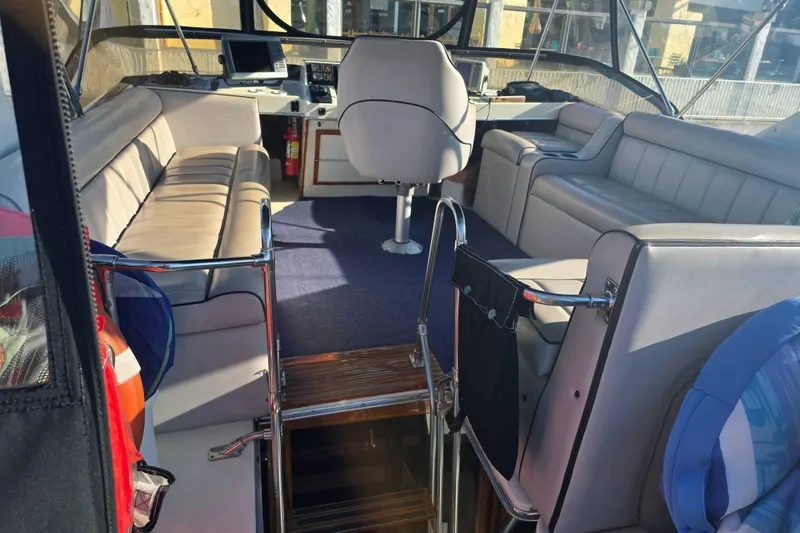 Slide: The Image of Interior of 1986 Bayliner 3870 Motoryacht with seating and navigation equipment. - 3