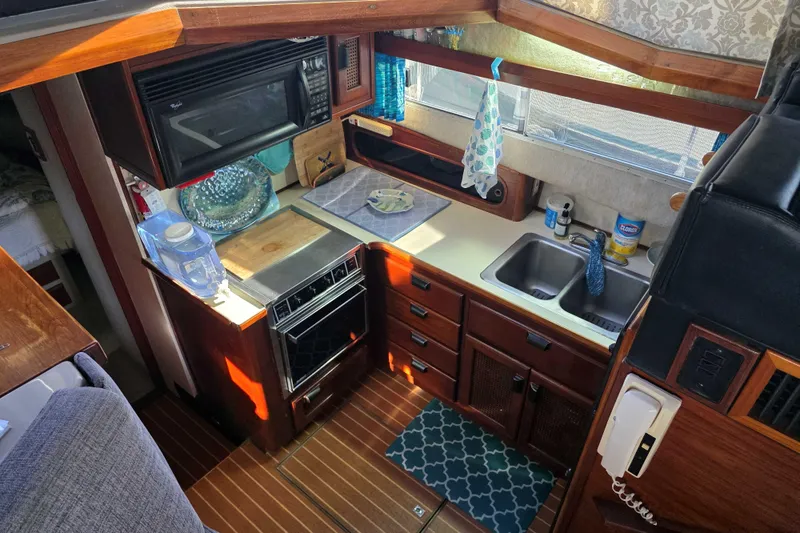 Slide: The Image of Interior of 1986 Bayliner 3870 Motoryacht kitchen with appliances and wooden cabinetry. - 5