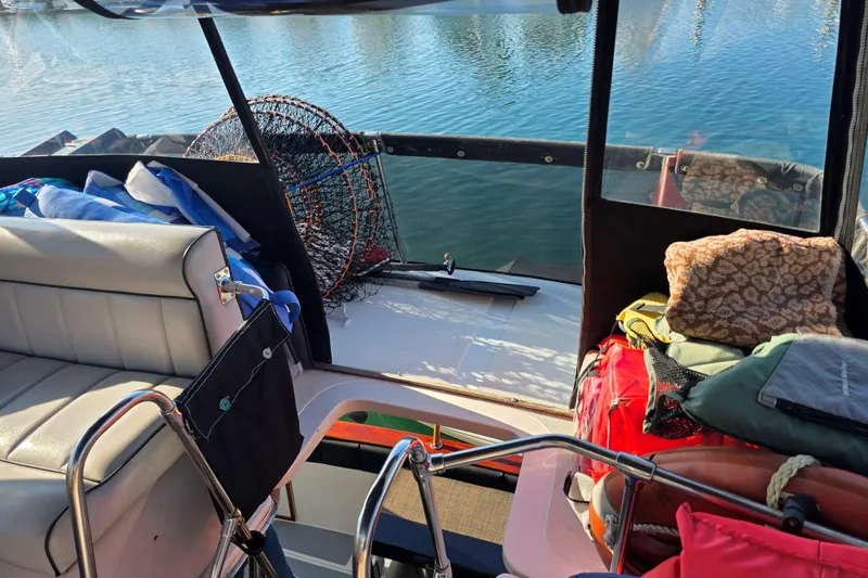 Slide: The Image of Interior view of a 1986 Bayliner 3870 Motoryacht with fishing gear and seating. - 6