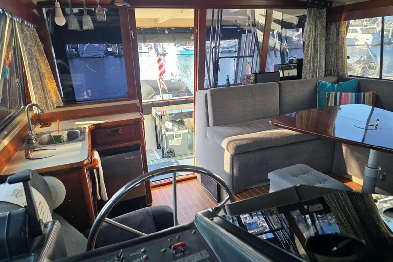 Slide: The Image of Interior of 1986 Bayliner 3870 Motoryacht with seating, table, and kitchenette. - 7