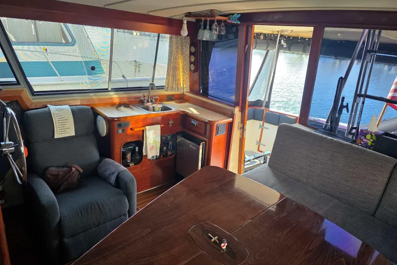 Slide: The Image of Interior of 1986 Bayliner 3870 Motoryacht with kitchen and seating area. - 8