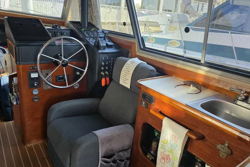 Slide: The Image of Interior of 1986 Bayliner 3870 Motoryacht with steering wheel and kitchenette. - 9