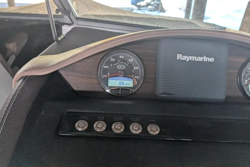 Slide: The Image of Dashboard of a 2013 Cobalt 26SD boat with Raymarine display and gauges. - 3