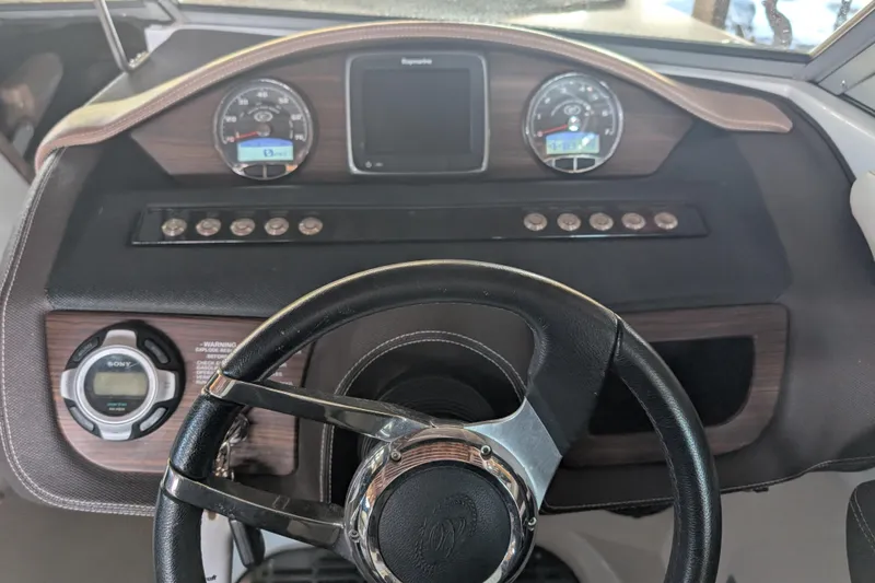 Slide: The Image of Dashboard of a 2013 Cobalt 26SD boat with steering wheel and gauges. - 4