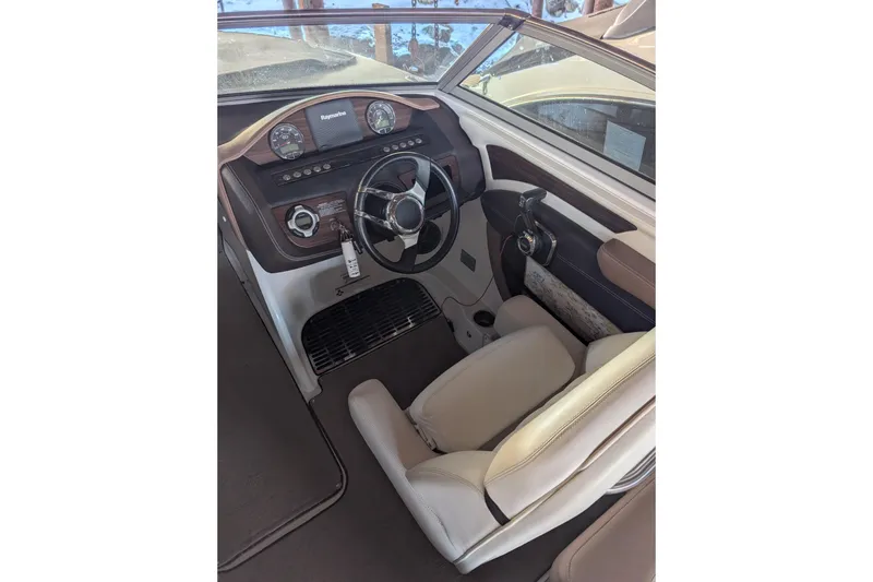 Slide: The Image of Interior view of a 2013 Cobalt 26SD boat cockpit with steering wheel and dashboard. - 5