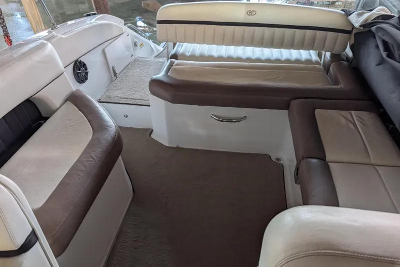 Slide: The Image of Interior seating of a 2013 Cobalt 26SD boat with brown and white upholstery. - 6
