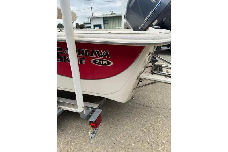 Slide: The Image of 2016 Carolina Skiff 218 DLV boat on trailer, red and white exterior. - 11