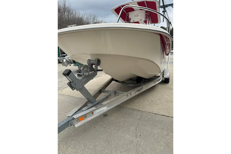Slide: The Image of 2016 Carolina Skiff 218 DLV boat on trailer, front view, parked outdoors. - 12