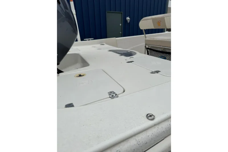 Slide: The Image of 2016 Carolina Skiff 218 DLV boat interior with seating and storage compartments. - 3