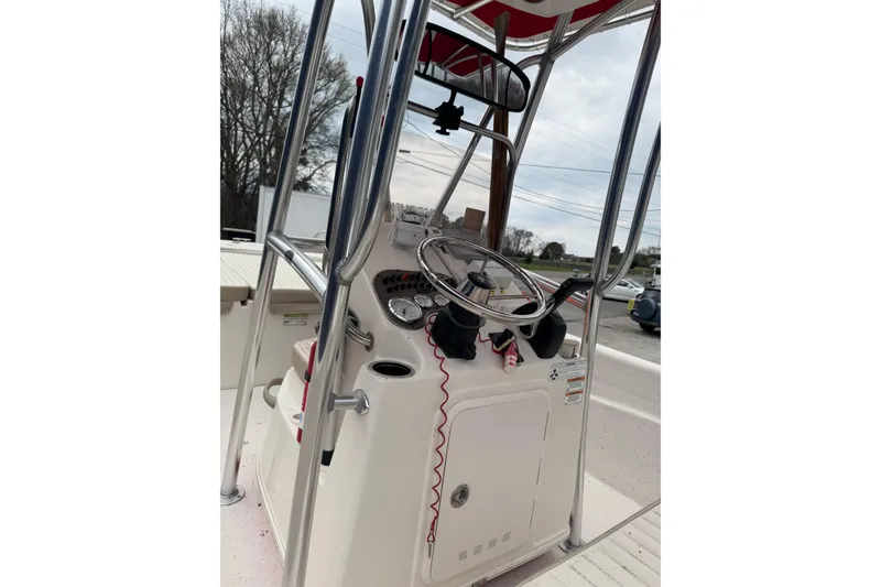 Slide: The Image of 2016 Carolina Skiff 218 DLV boat console with steering wheel and controls. - 7