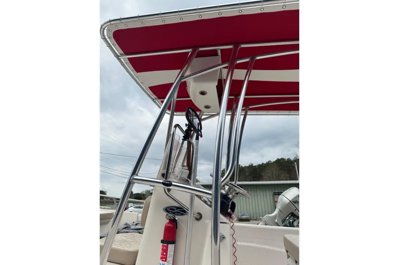 Slide: The Image of 2016 Carolina Skiff 218 DLV boat with red canopy and stainless steel frame. - 8