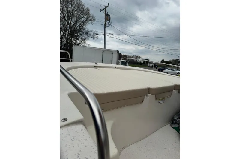 Slide: The Image of 2016 Carolina Skiff 218 DLV boat deck with railing under cloudy sky. - 9