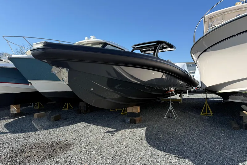 The Image of 2024 Skipper-BSK 38NC boat on stands, displayed outdoors under clear blue sky. - 0