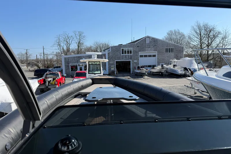Slide: The Image of 2024 Skipper-BSK 38NC boat at a marina with surrounding vessels and buildings. - 11