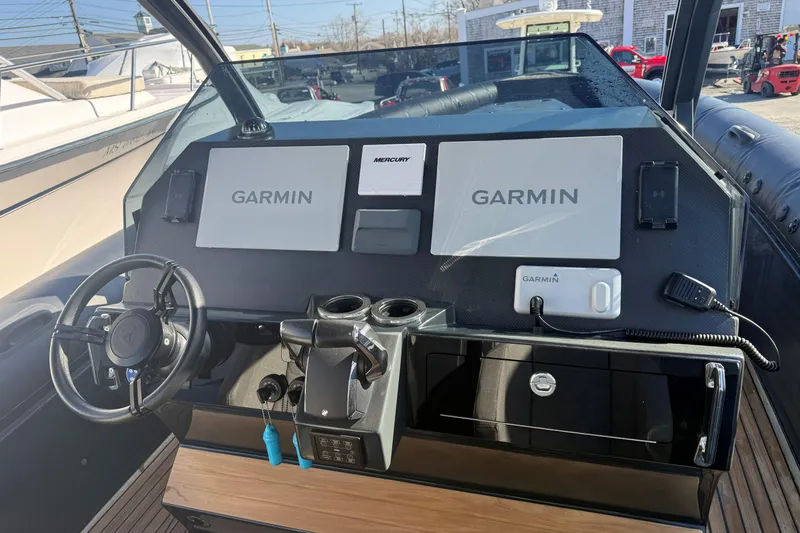 Slide: The Image of 2024 Skipper-BSK 38NC boat dashboard with Garmin navigation systems and Mercury controls. - 12