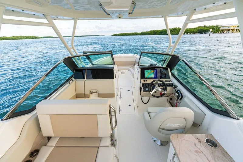Slide: The Image of Manufacturer Provided Image: 2026 Boston Whaler 240 Vantage boat interior with helm, seating, and navigation system on open water. - 4