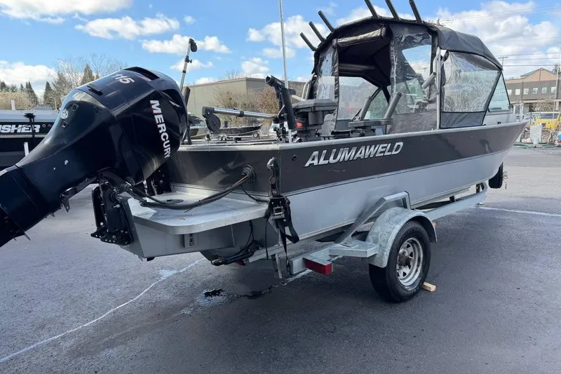 Slide: The Image of 2010 Alumaweld Blackhawk 202 boat with Mercury engine on trailer, parked outdoors. - 3