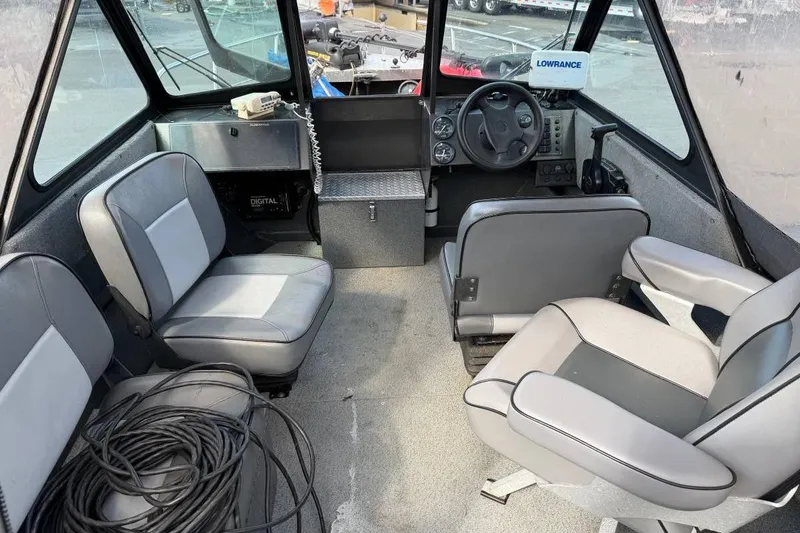 Slide: The Image of Interior of a 2010 Alumaweld Blackhawk 202 boat with seating and steering console. - 6