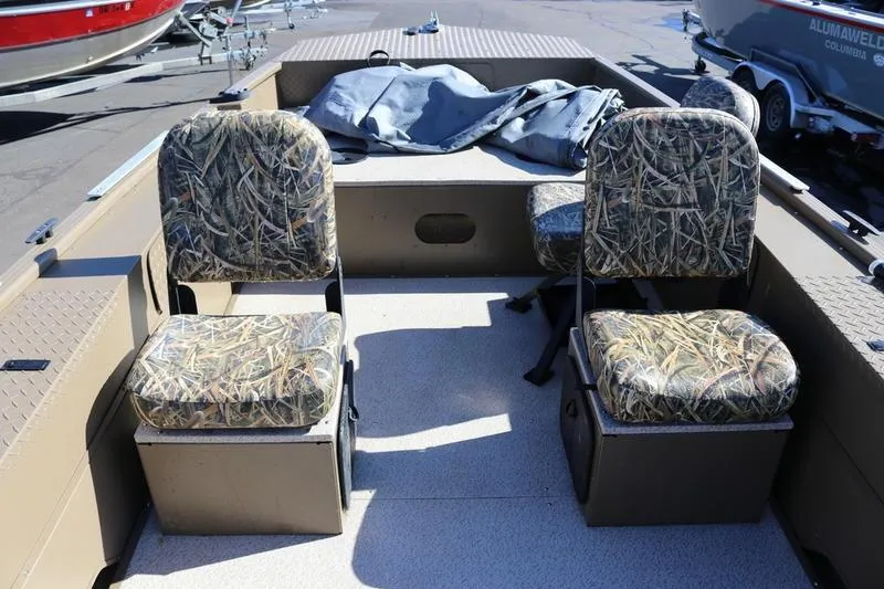 Slide: The Image of 2025 Smoker Craft Pro Sportsman 1866 boat interior with camo seats and storage compartments. - 11