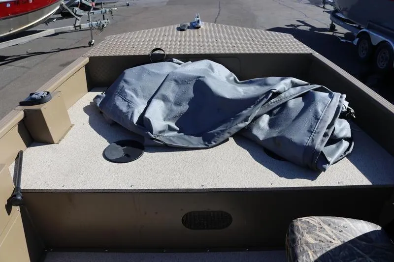 Slide: The Image of 2025 Smoker Craft Pro Sportsman 1866 boat deck with covered equipment. - 9