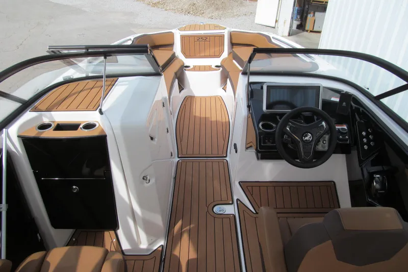 Slide: The Image of 2025 Yamaha Boats 252SD interior with sleek dashboard and modern seating design. - 11