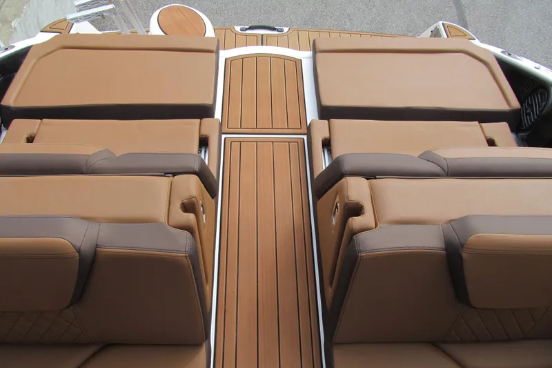 Slide: The Image of 2025 Yamaha Boats 252SD interior with luxurious brown seating and sleek wooden flooring. - 18