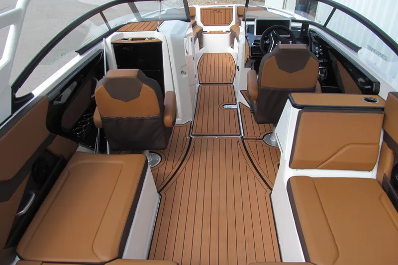 Slide: The Image of 2025 Yamaha Boats 252SD interior with luxurious brown seating and sleek design. - 5