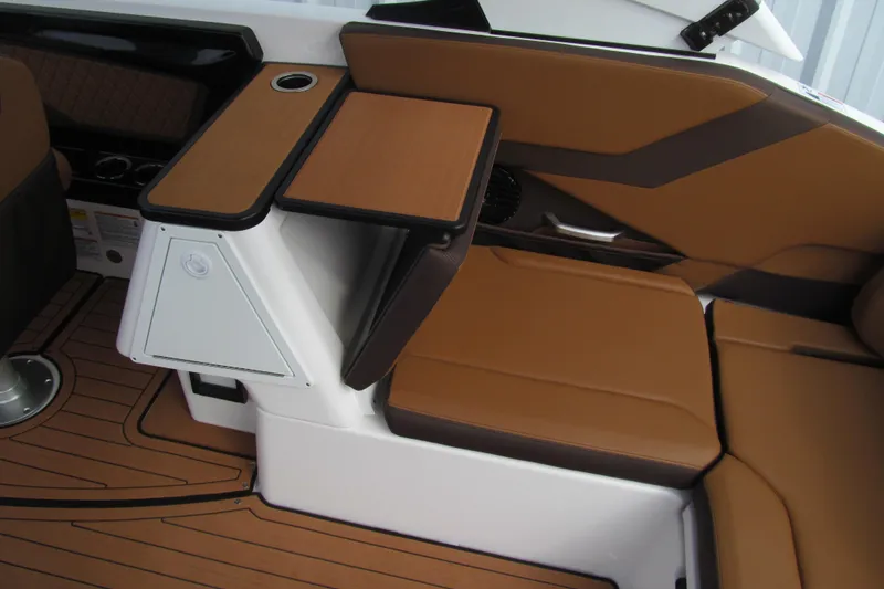 Slide: The Image of Interior of 2025 Yamaha Boats 252SD, featuring brown seating and foldable table. - 7