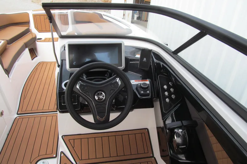 Slide: The Image of 2025 Yamaha Boats 252SD helm with modern controls and wood-style flooring. - 8