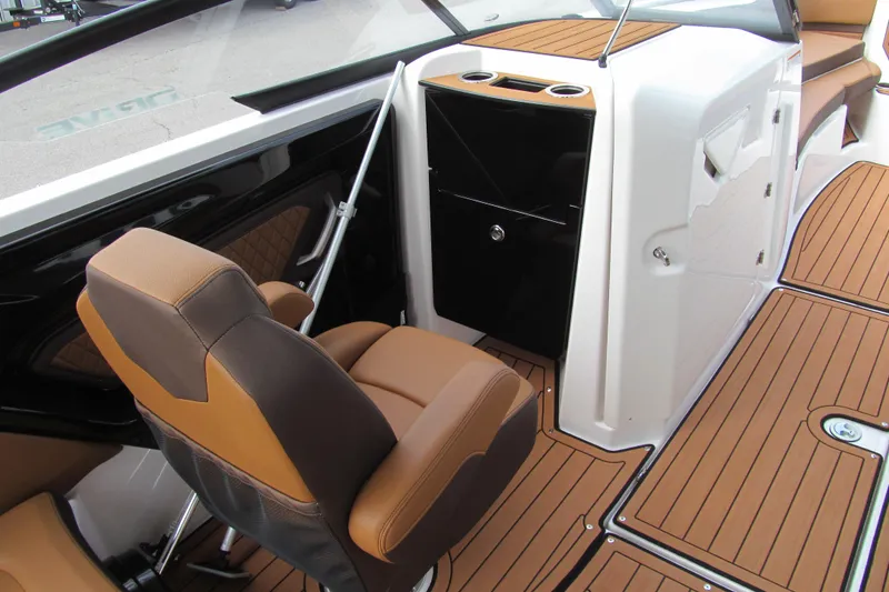 Slide: The Image of 2025 Yamaha Boats 252SD interior with brown seating and sleek design. - 9