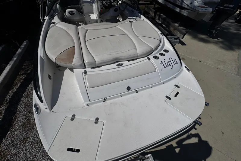 Slide: The Image of 2008 Rinker 226 Captiva Bowrider boat with white seating and "Alafia" text on the stern. - 2