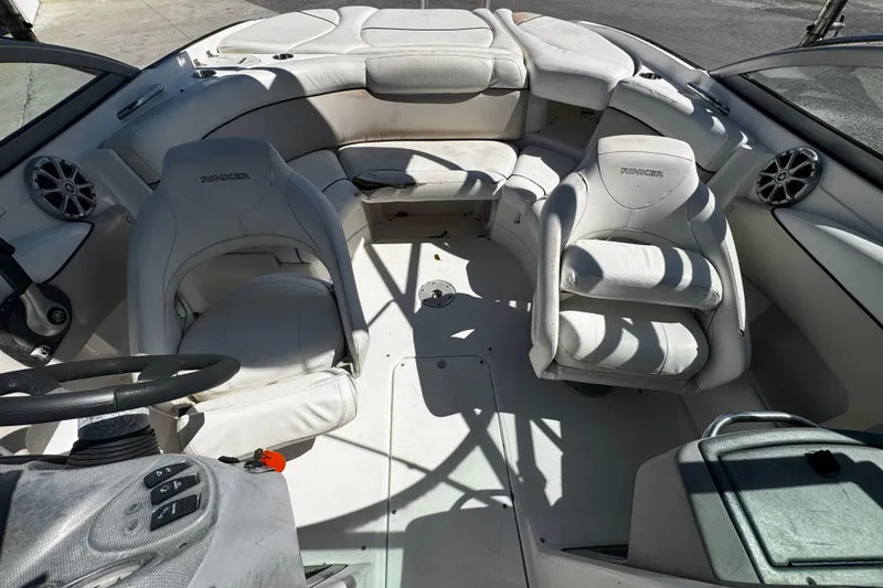 Slide: The Image of 2008 Rinker 226 Captiva Bowrider interior with white seating and steering wheel. - 5